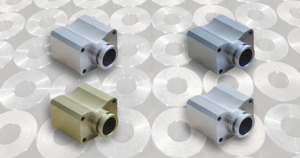 CNC metal parts made from aluminum brass steel and stainless steel on a light background